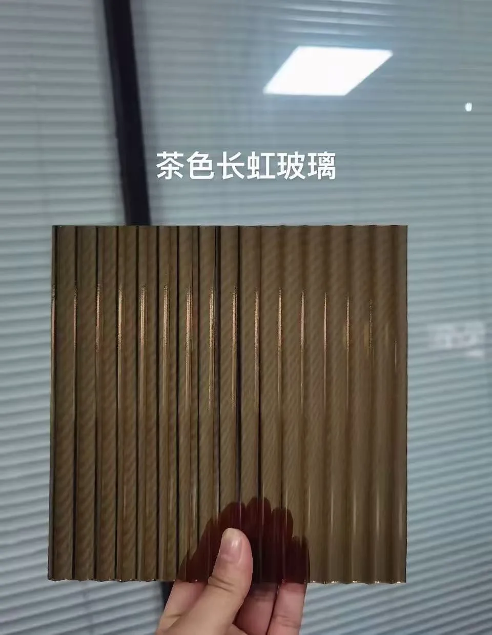 Bronze-coloured linear-textured glass sample