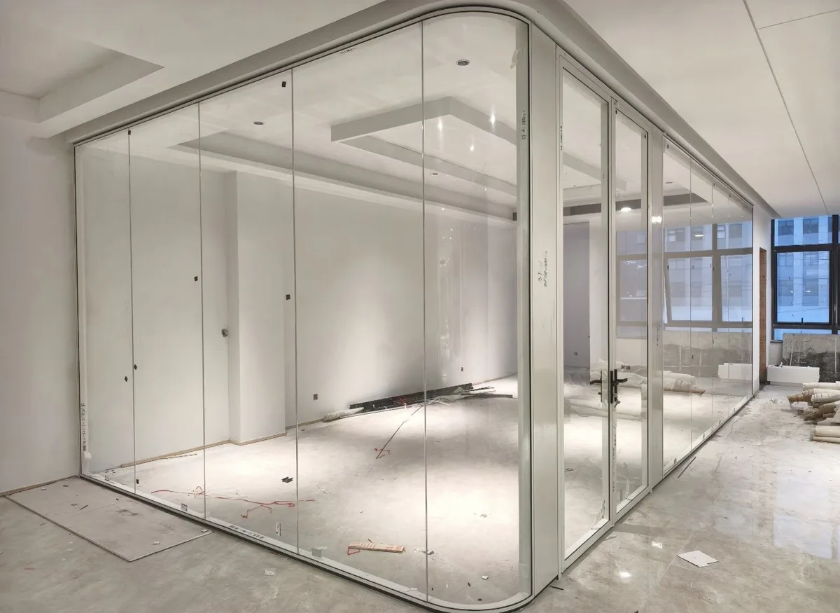 Interior partition with curved low-iron glass corner panels