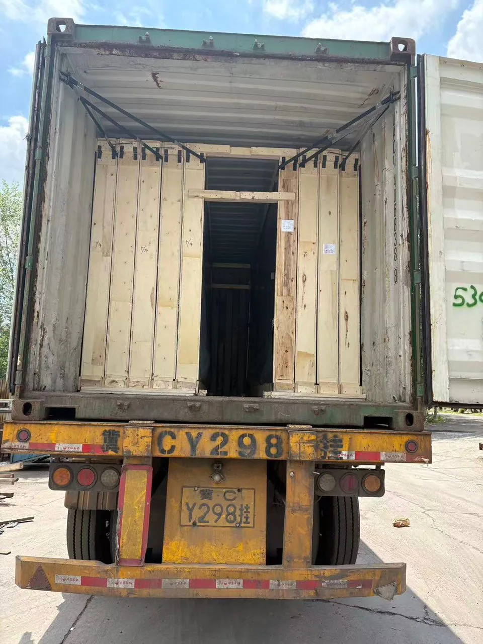 Packed glass crates shown inside a shipping container.